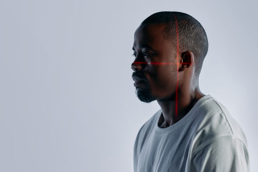 A person's face being scanned by facial-recognition lines