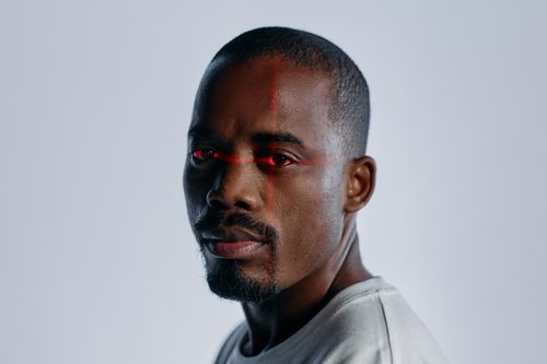Free Close-up of a man with a futuristic laser scanning effect over his eyes, suggesting technology and identity themes. Stock Photo