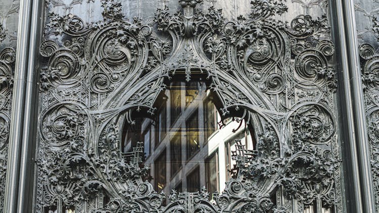 Gray Iron Carving With Gothic Design On Glass Window