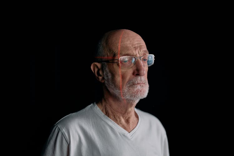 Photo Of An Old Man With Laser Lines On His Face