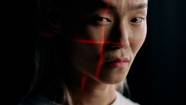 A close-up of an expressive face with facial recognition technology in a studio setting