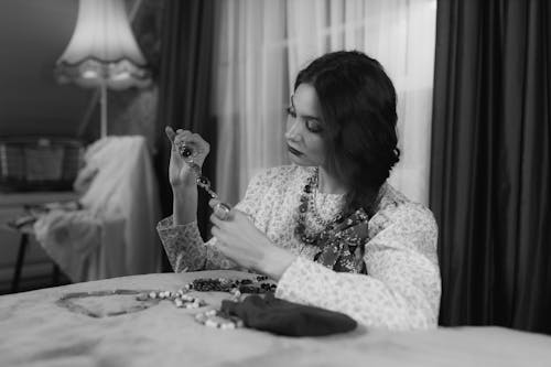 Grayscale Photo of a Woman Holding an Accessory