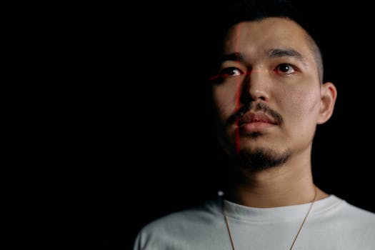 Studio portrait of a man with laser facial recognition on black background.