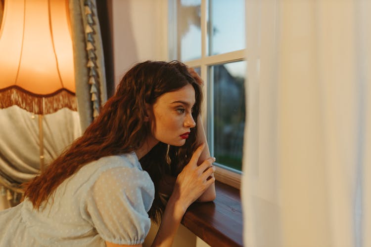 Young Woman Looking Out The Window