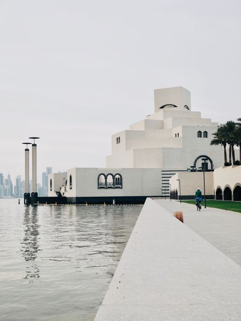 A modern architectural view of the Museum of Islamic Art in Doha, Qatar, by the sea.