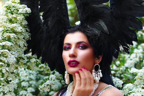 Close-up Photo of an Alluring Woman with Black Feather Headdress