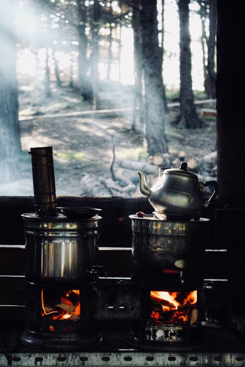 Free Traditional cooking stoves with kettles in a Turkish forest setting. Stock Photo