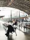 People Sitting on Bench Inside Building