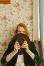 Girl in Green Long Sleeve Shirt Holding Black Round Plate