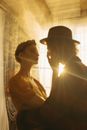 Man in Black Hat Beside Woman in White Shirt