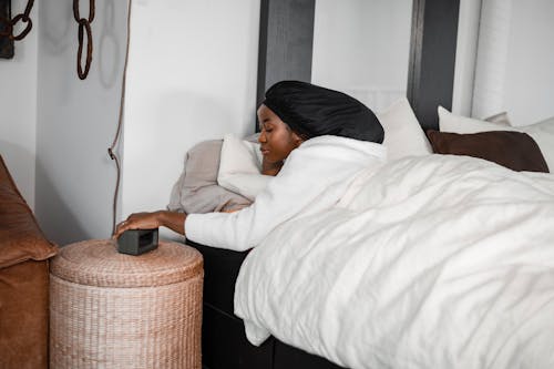 Woman Wearing Headscarf Lying in Bed 