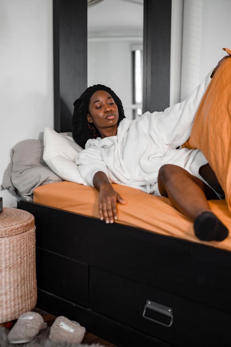 A Woman In White Getting Up The Bed