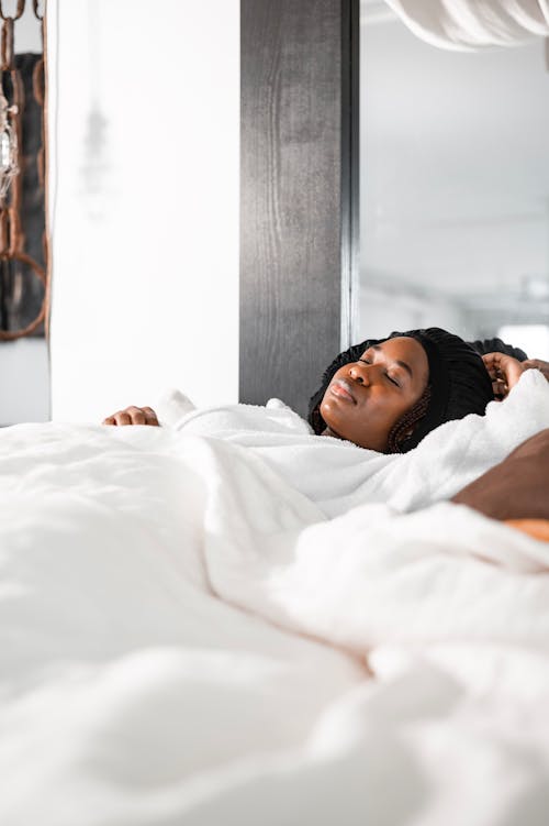 Free Woman in White Shirt Lying on Bed Stock Photo