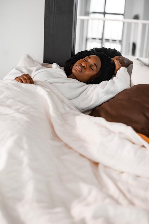 Free A Woman Lying on the Bed Stock Photo