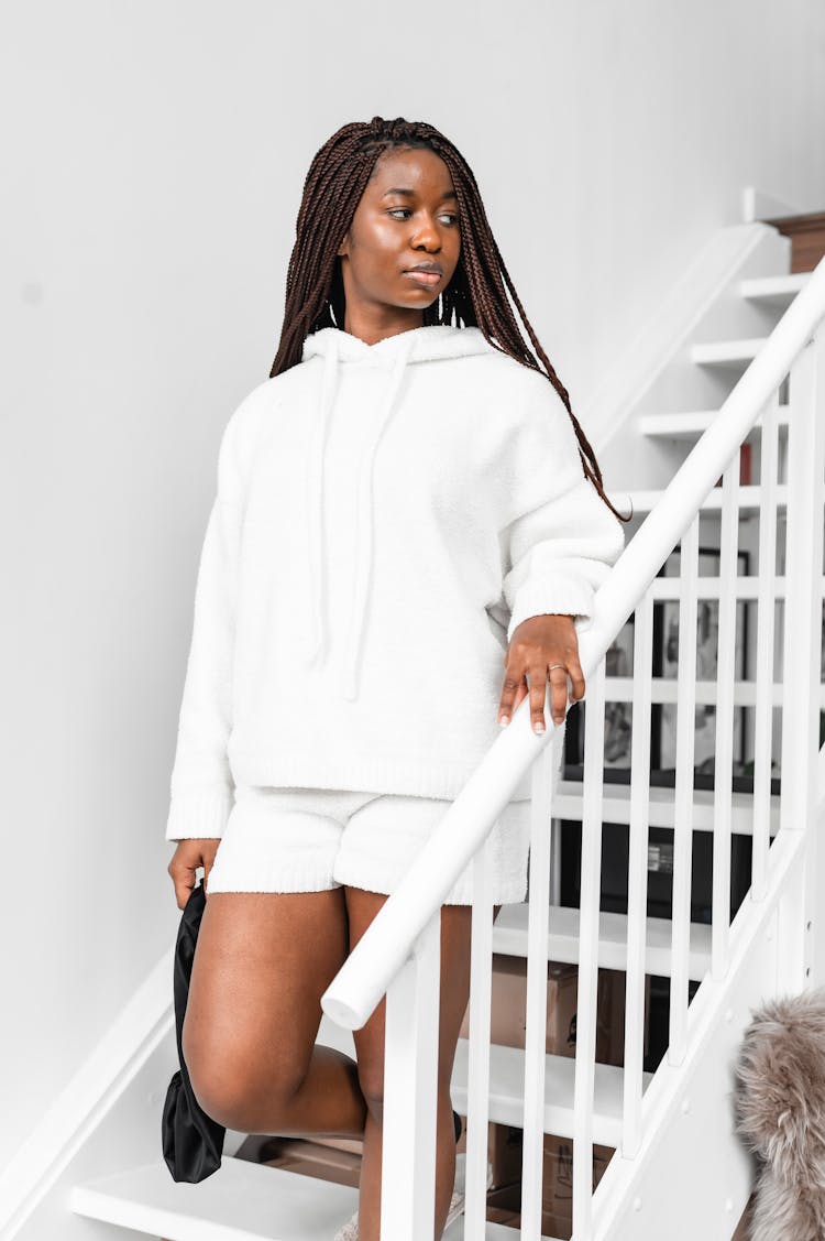 Woman In White Jacket Going Down The Stairs