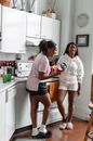 Women Standing and Laughing at the Kitchen