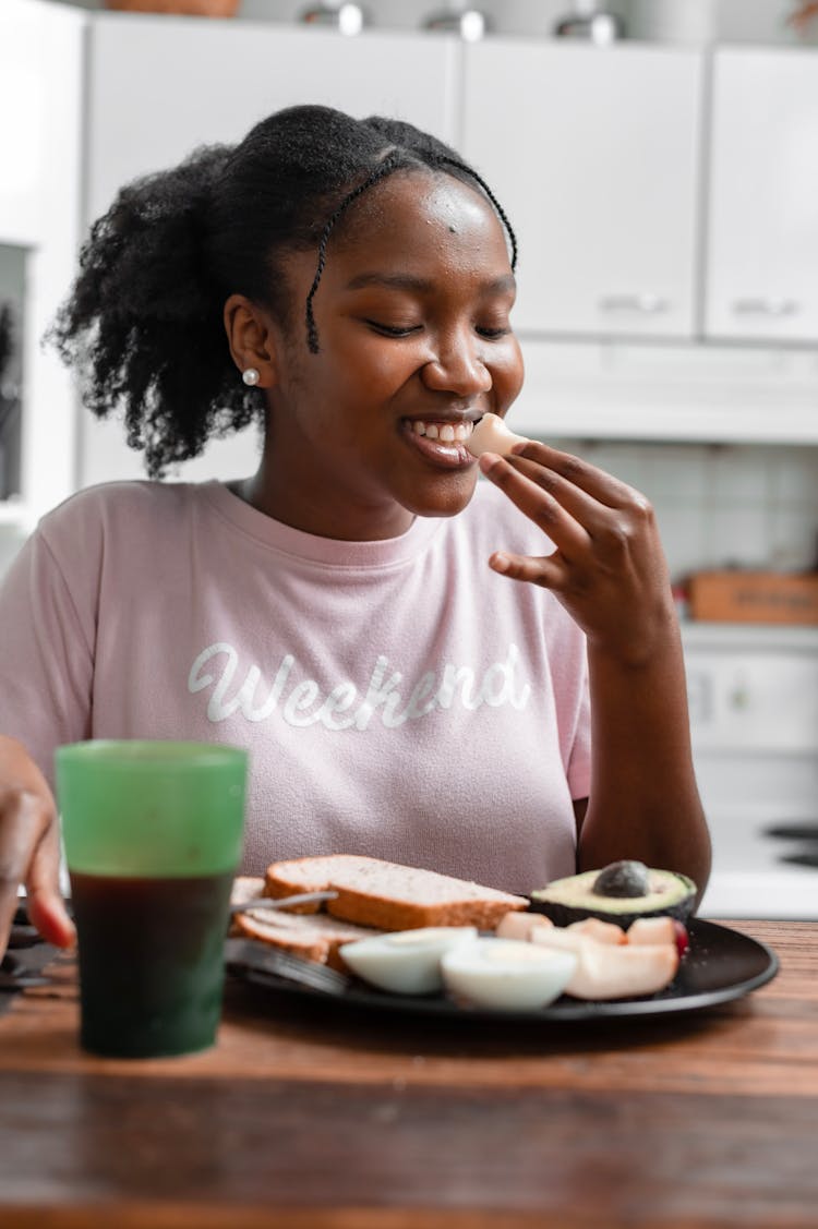 Smiling Woman Eating Fruits And Bread For Breakfast