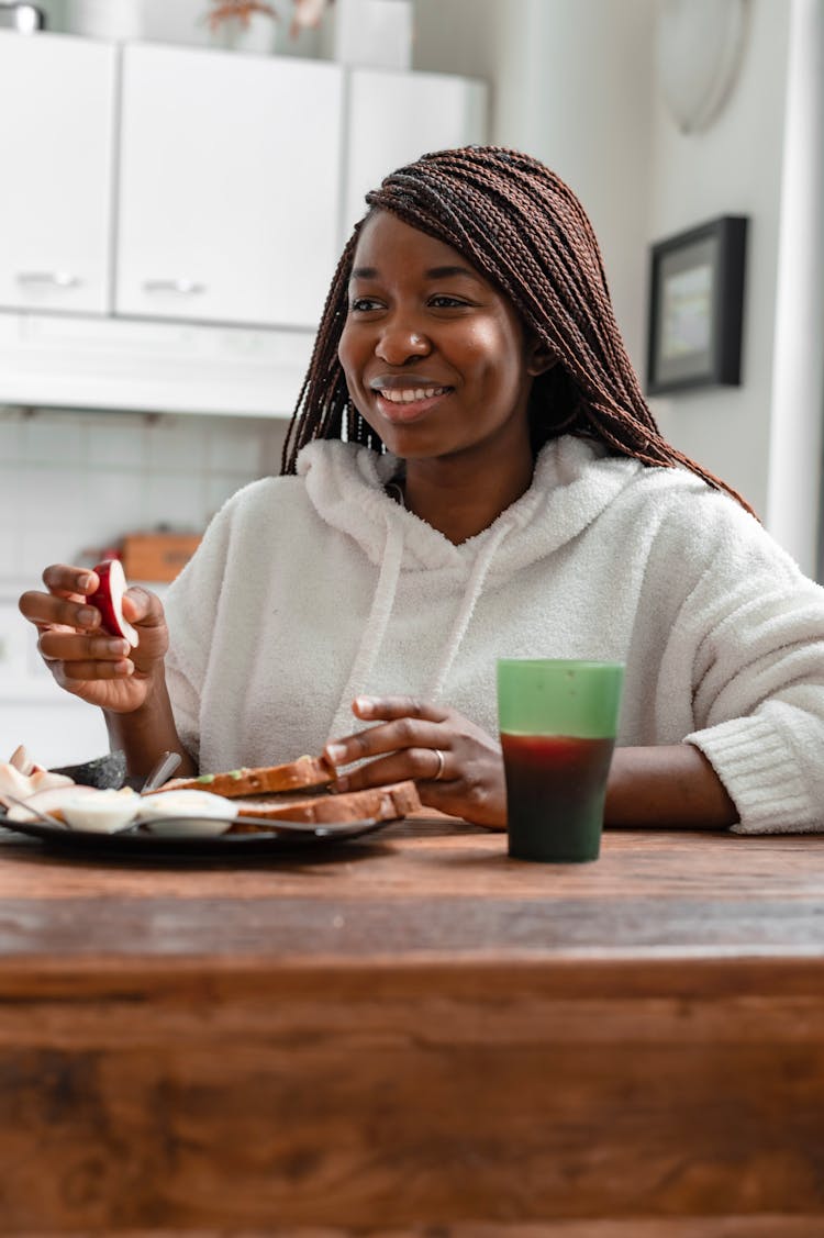 Woman In White Hoodie Eating Her Breakfast