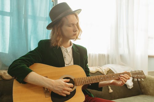 Woman in Black Blazer Playing Brown Acoustic Guitar