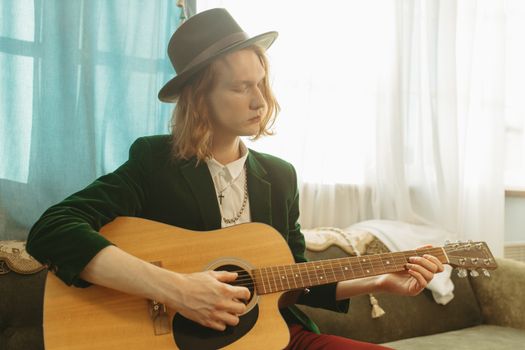 Woman in Black Blazer Playing Brown Acoustic Guitar
