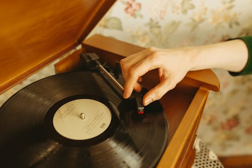 Person using a Wooden Phonograph Player 