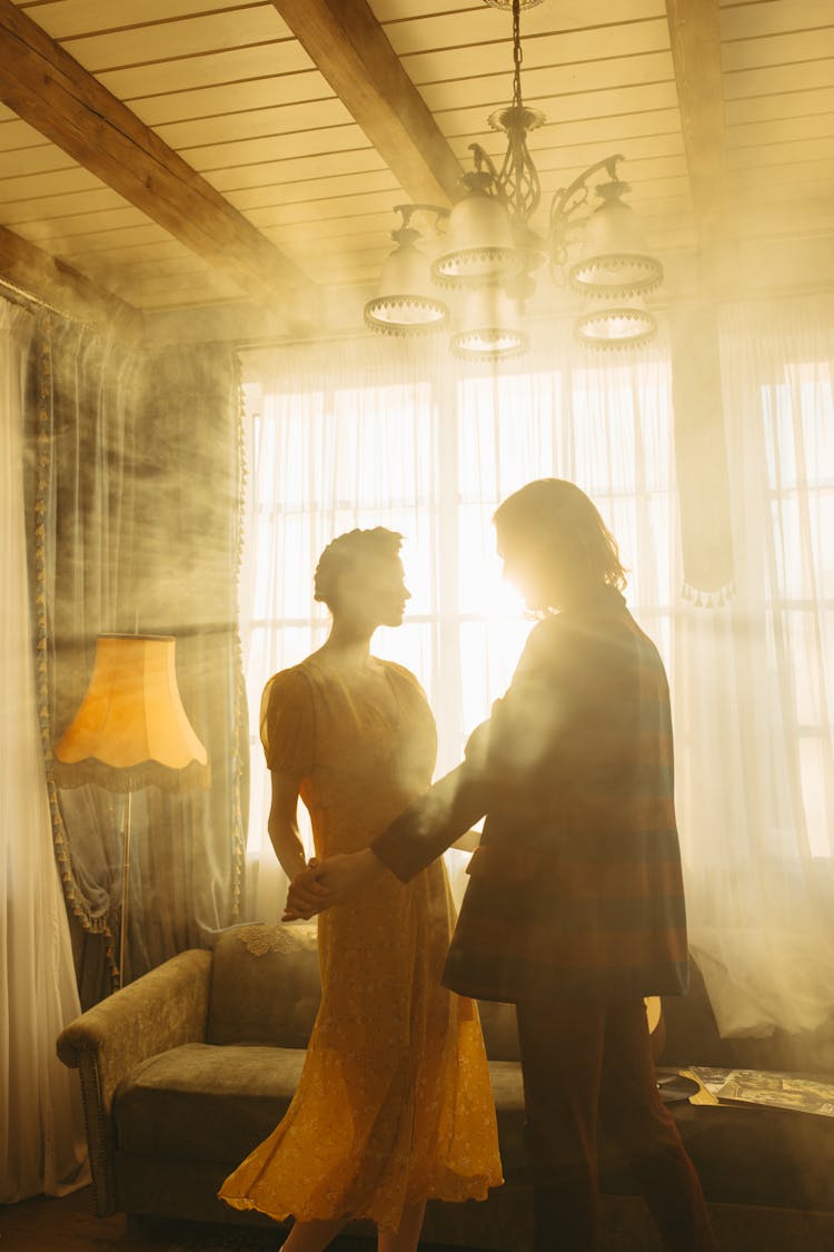 A Couple Dancing In A Living Room