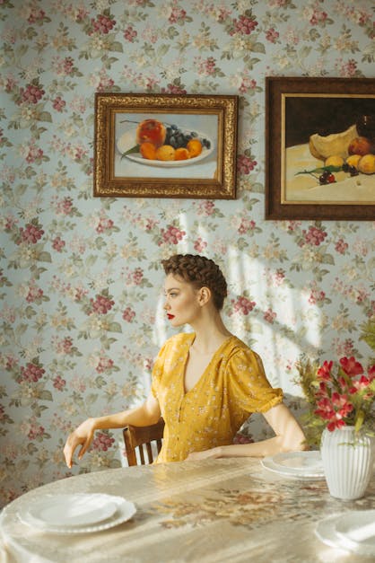 Woman Sitting at the Table with Floral Wallpaper Background · Free ...