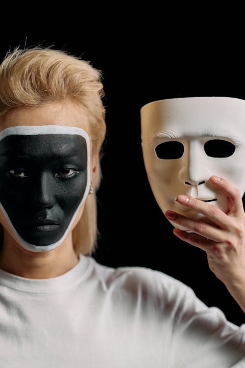 Photo of Man Holding White Face Mask