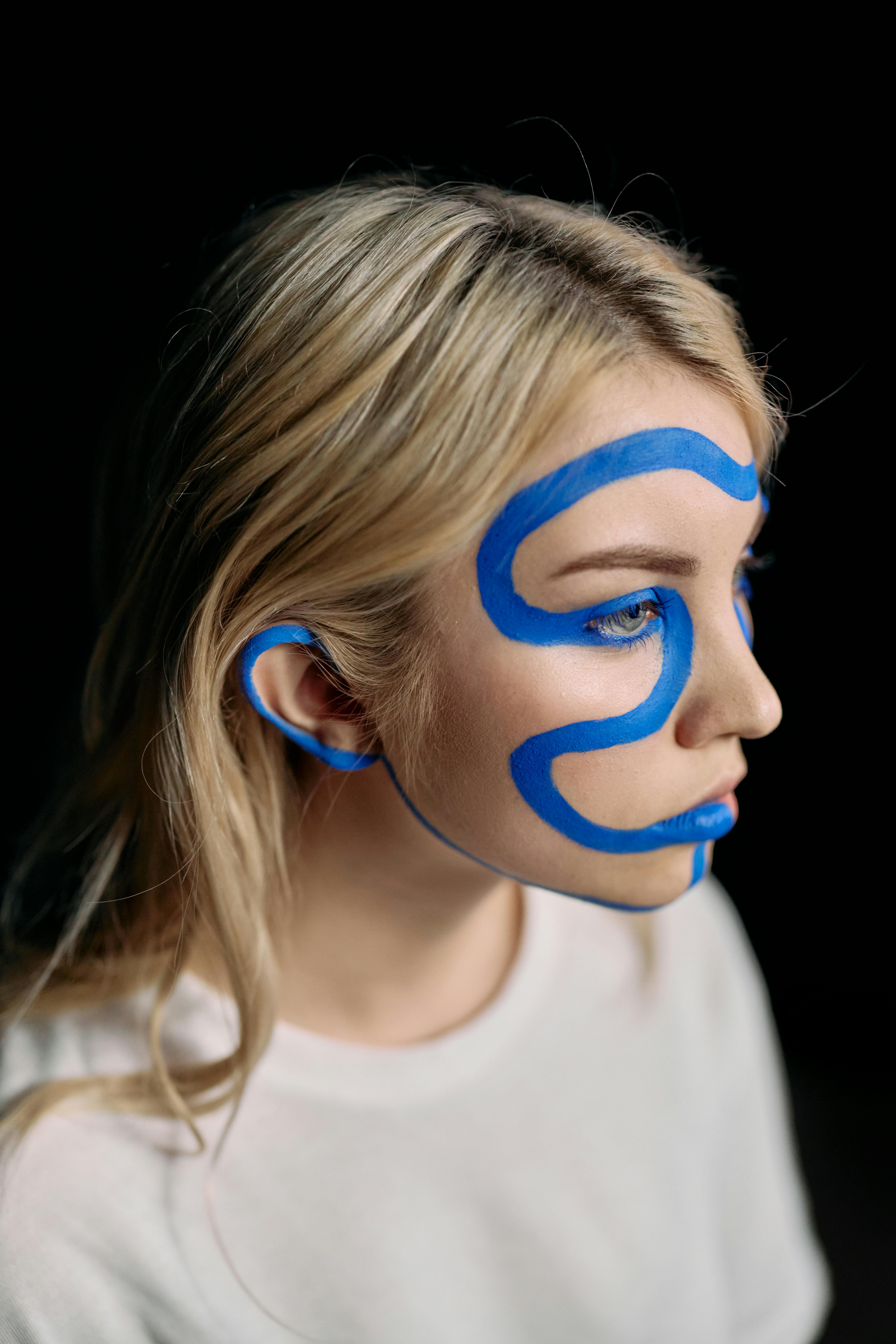 Woman in White Crew Neck Shirt With Blue Eyes