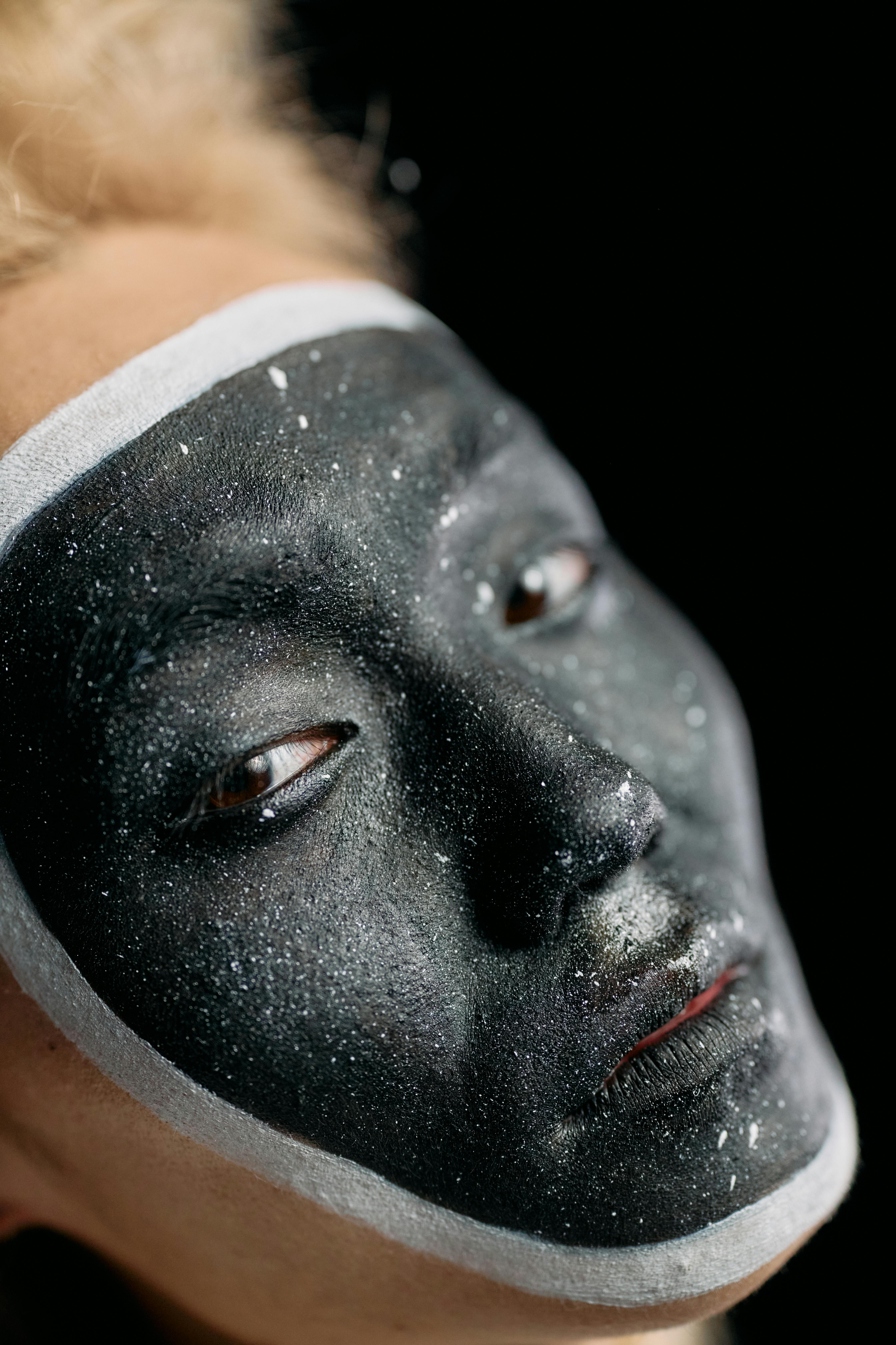 Close Up Photo of Man with Black Face Paint · Free Stock Photo