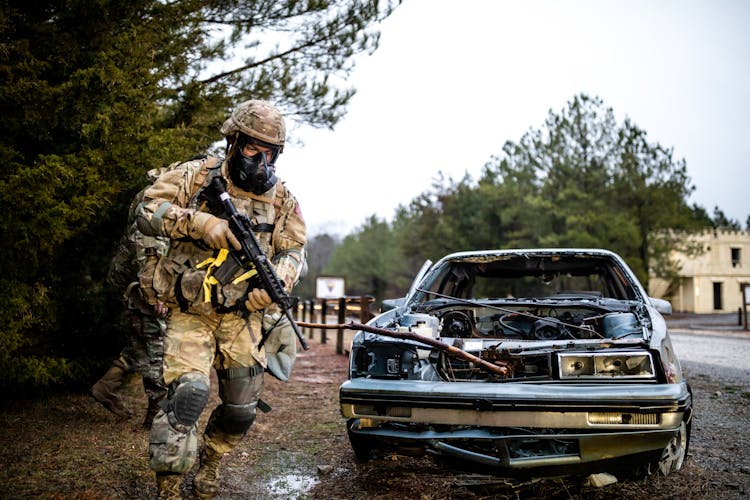 
A Soldier Running While Holding His Gun