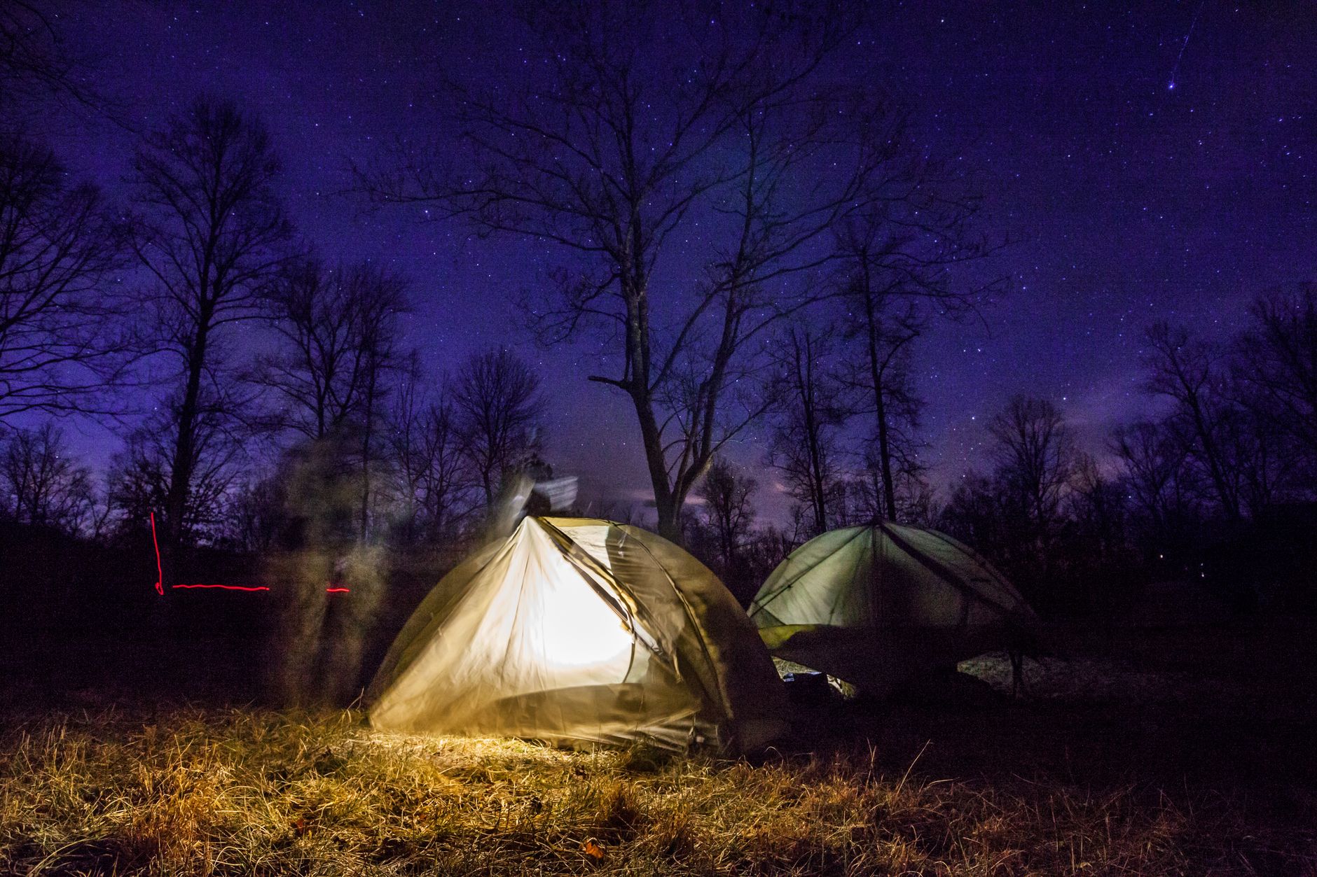 backpacker sleeping under stars wilderness