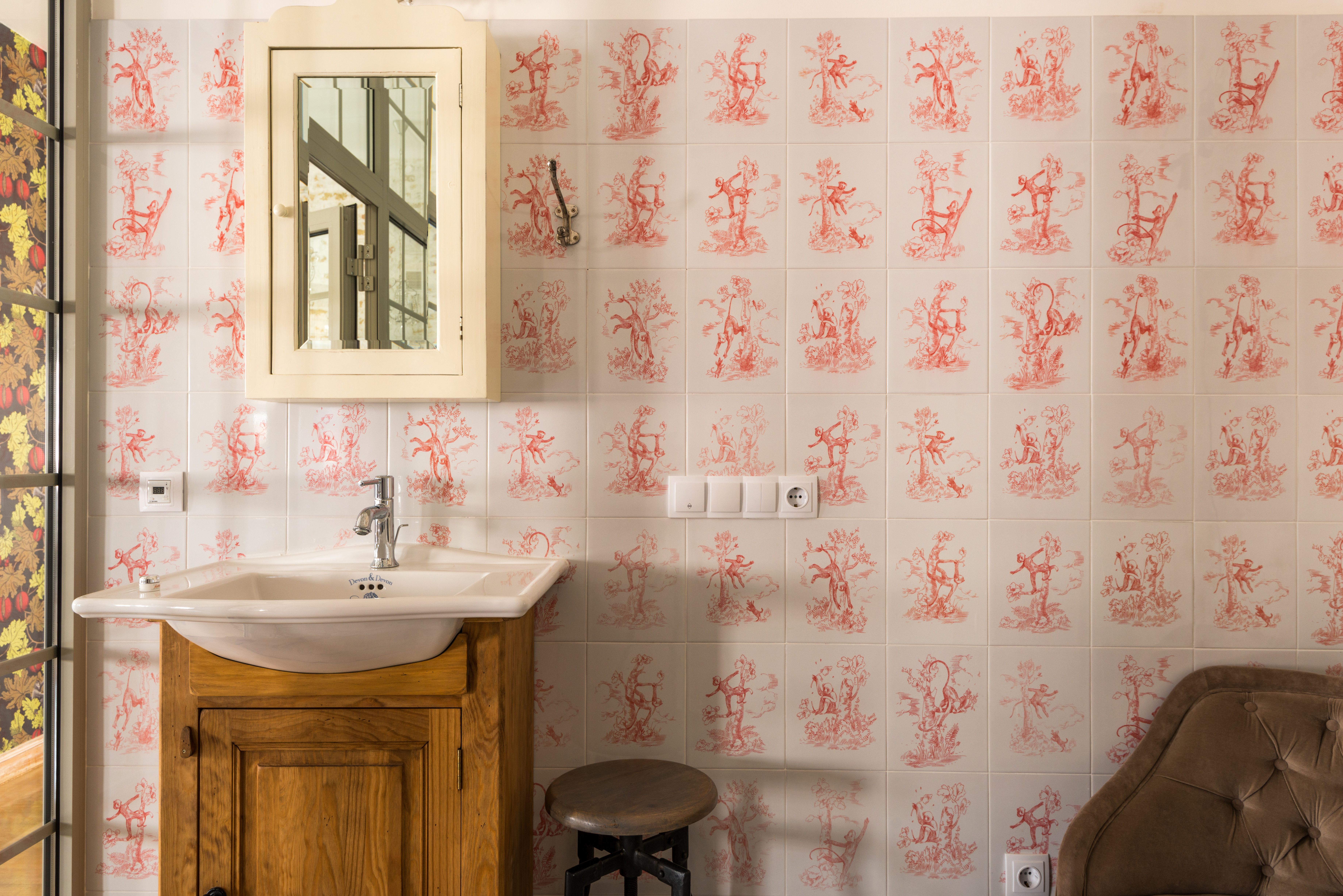 Wallpapering in South Woodford — careful masking before painting begins