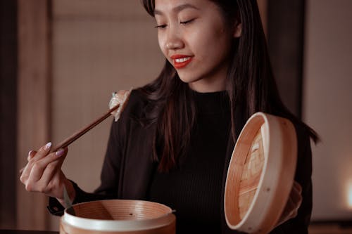 Free A Woman Eating Dumpling  Stock Photo