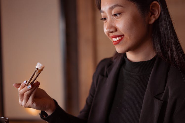 A Woman Eating Chinese Food 