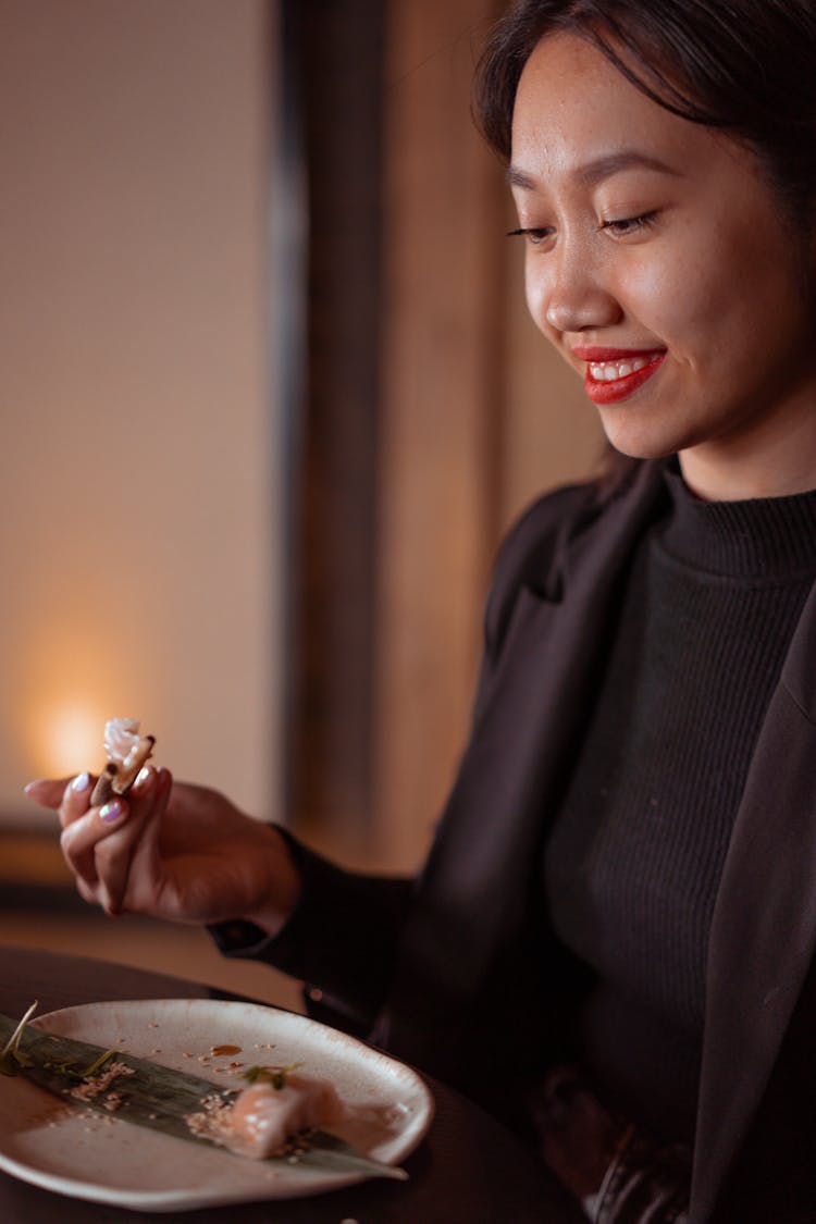 A Woman Eating A Dumpling