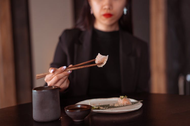 Woman Holding Chopsticks With Food