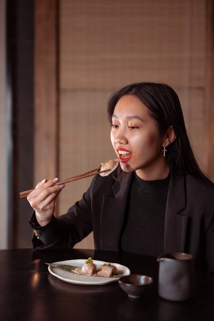 A Woman Eating A Dumpling