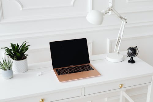 Macbook on White Wooden Desk