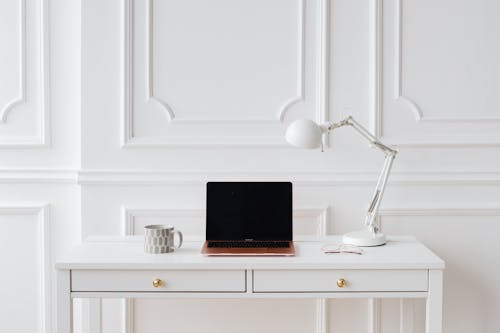 Laptop Computer on White Wooden Desk