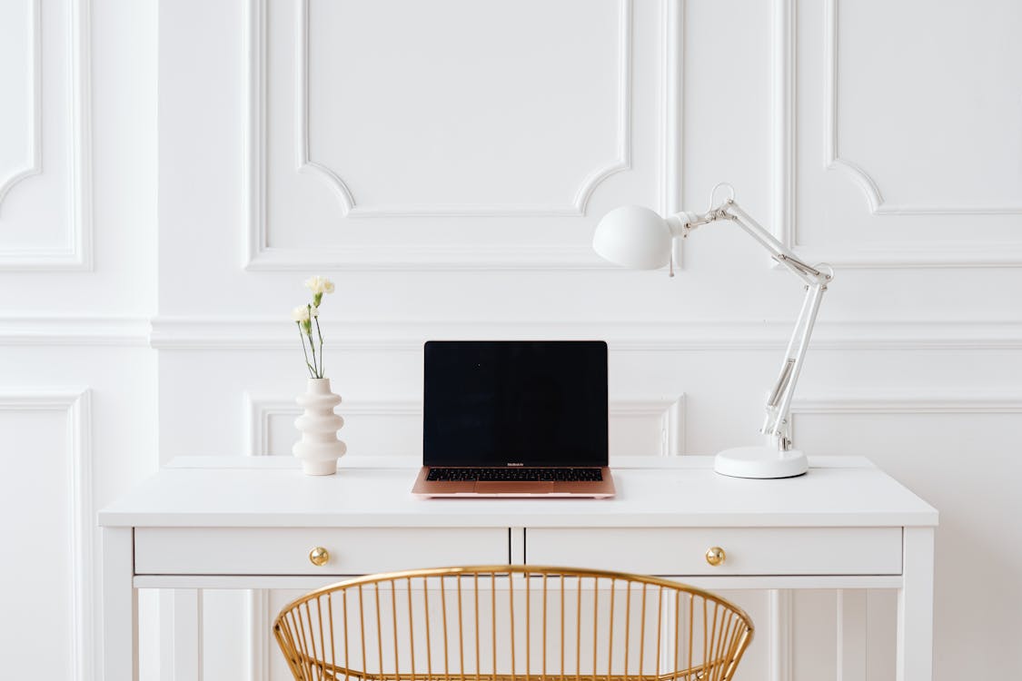 Free Laptop on a Wooden White Desk Stock Photo