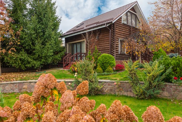 Rustic wooden cabin surrounded by autumn foliage. Photo by Max Vakhtbovych on Pexels