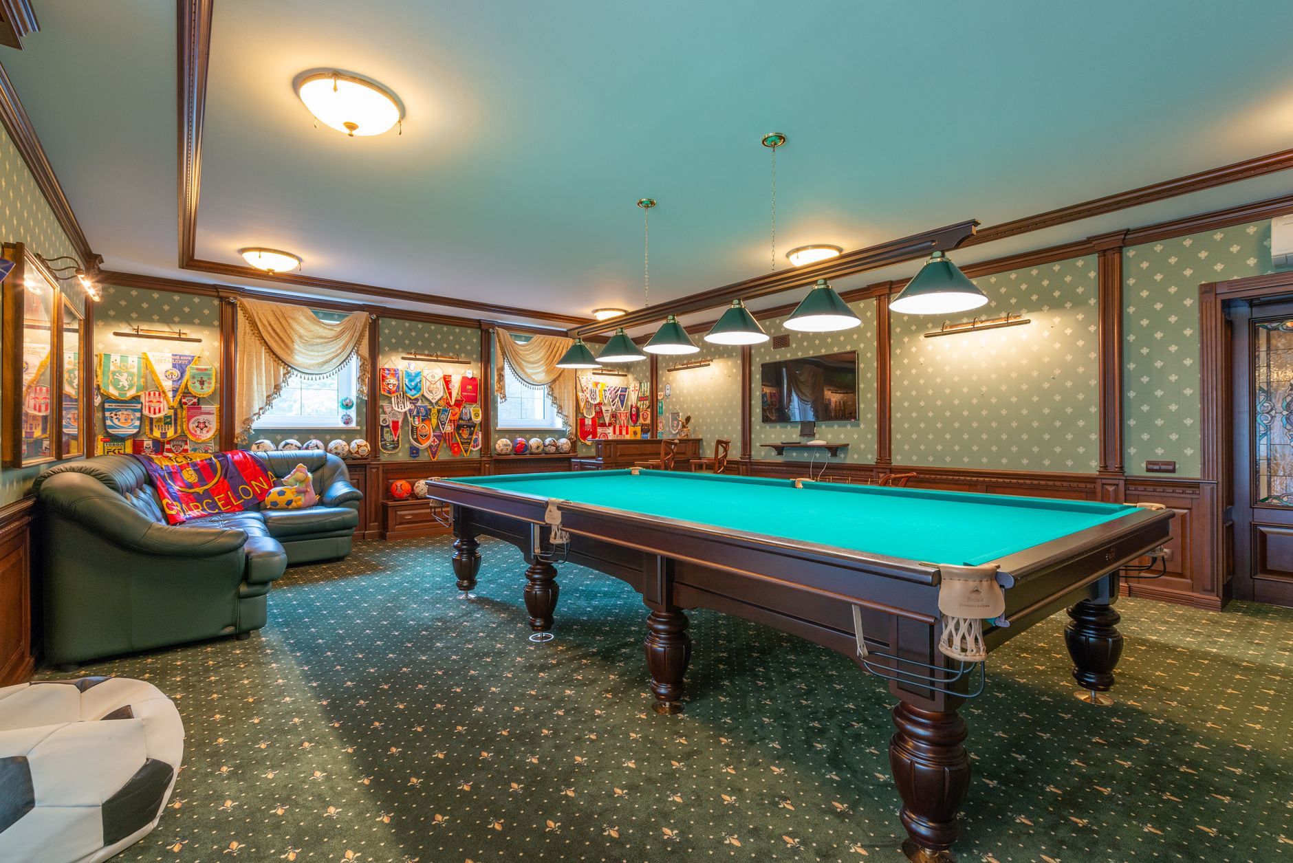 Elegant billiard room with vibrant decor and classic furnishings.