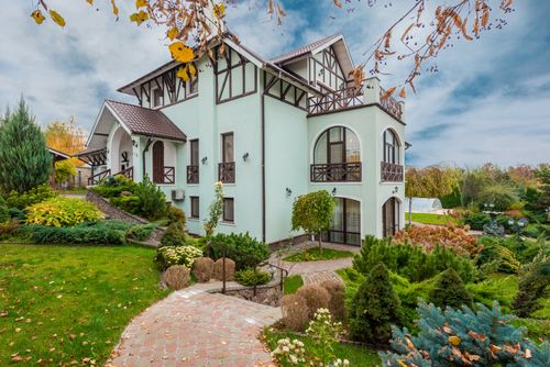 Free Beautiful traditional house with a garden in autumn showcasing architecture and landscaping. Stock Photo