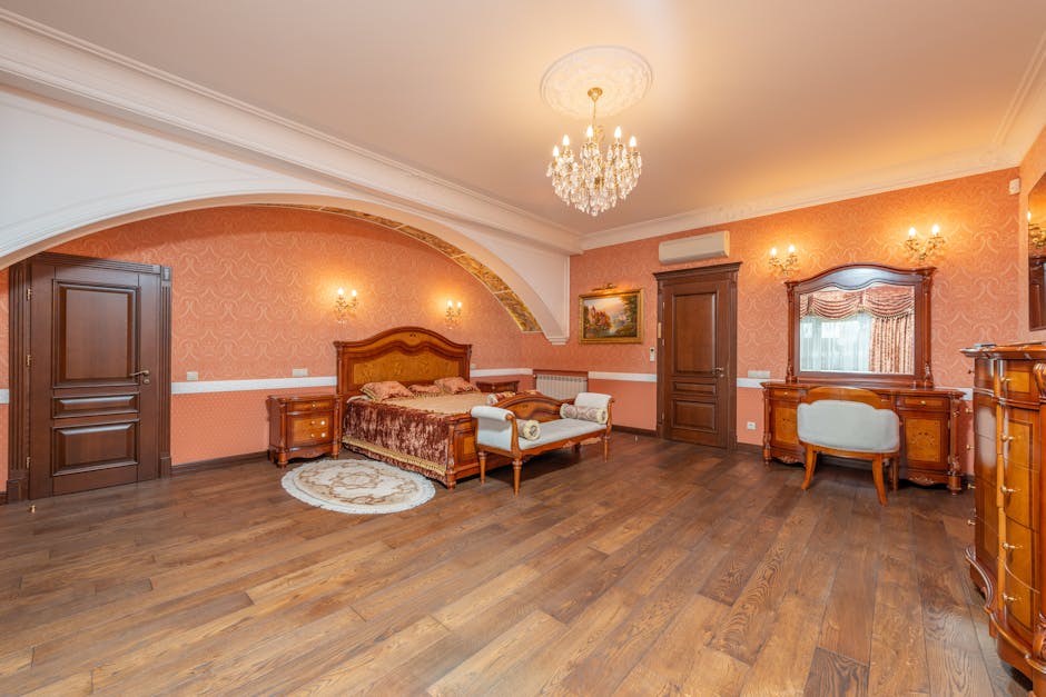 bedroom furniture UK - Luxurious classic bedroom featuring vintage wooden furniture and chandelier lighting.