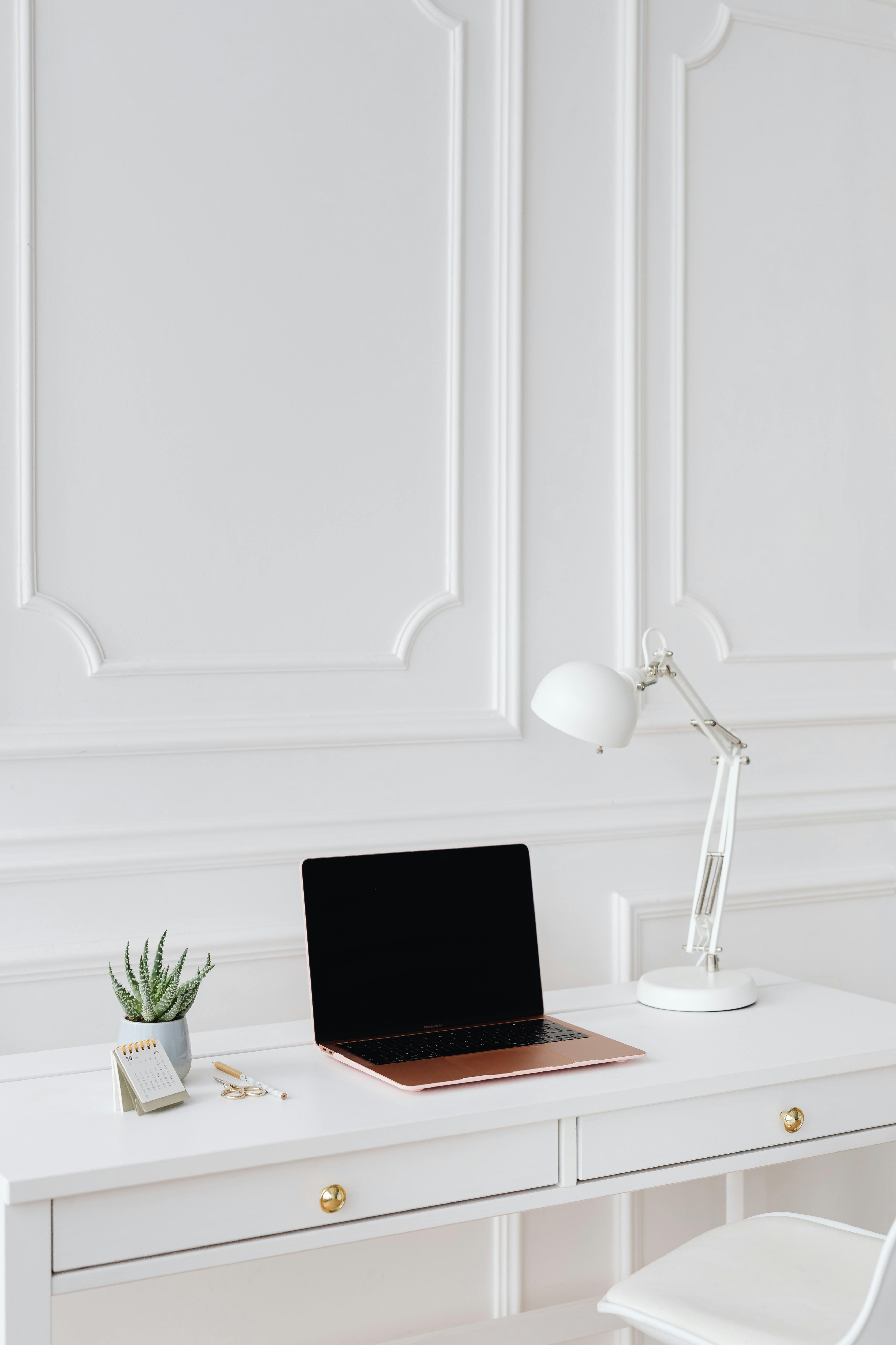 A Laptop and Desk Lamp on the Table · Free Stock Photo