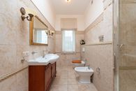 White Ceramic Sink Near Brown Wooden Door