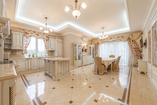 Bright, spacious kitchen and dining room with classic decor and chandeliers.