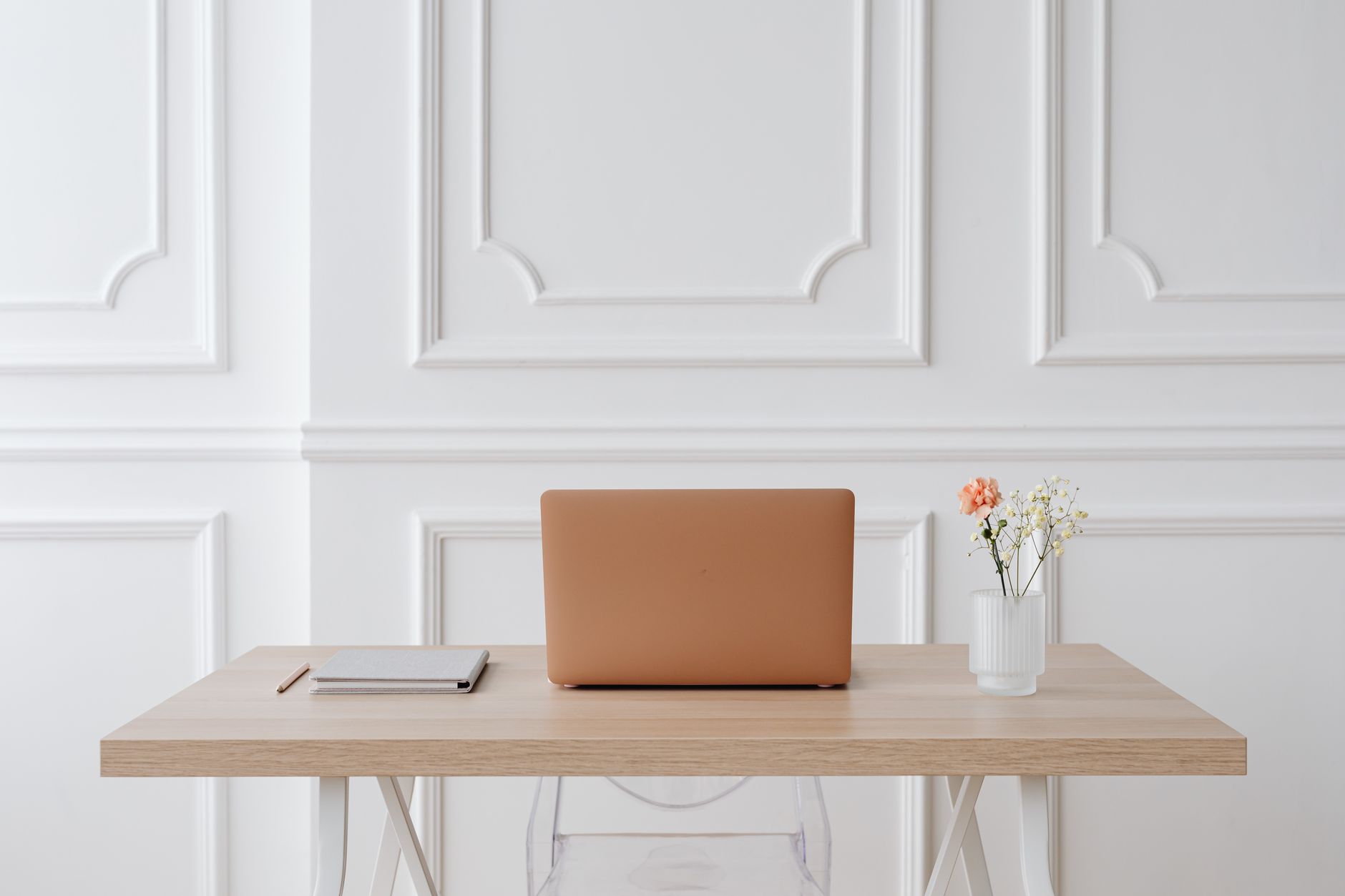 A quiet home desk with a closed casino app, budget worksheet, and national gambling support information