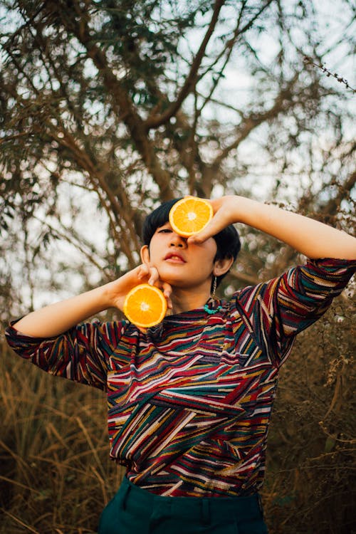 Woman Holding A Sliced Orange Fruit